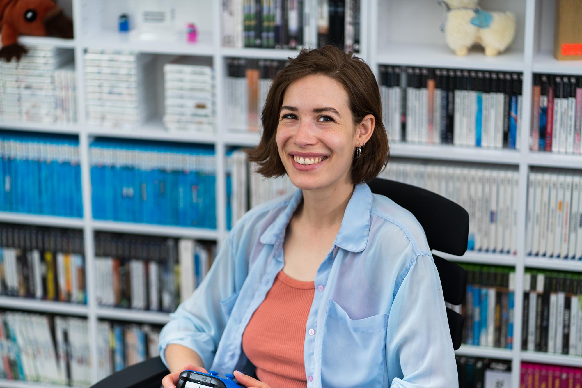 Mara Schulze sitting on an office chair and smiling.
