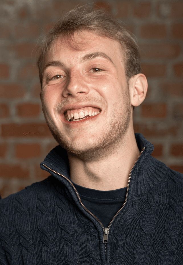 Portrait of Stefan Wilhelm with a smiley face and blond hair.