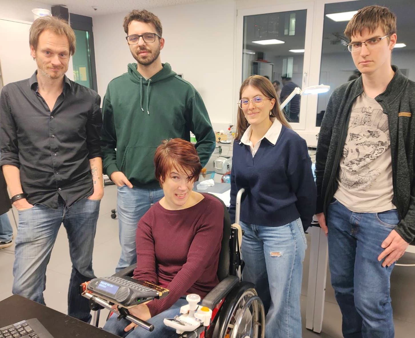 The student team behind the Custom Game Station project and co-designer Natascha Toman demonstrate the wheelchair joystick they have developed, mounted on a wheelchair.