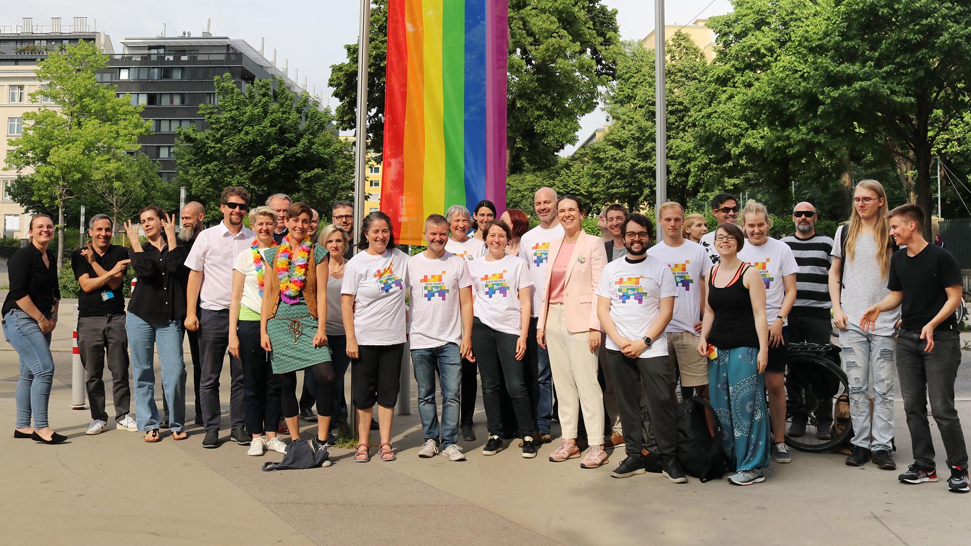 Large group in front of pride flag