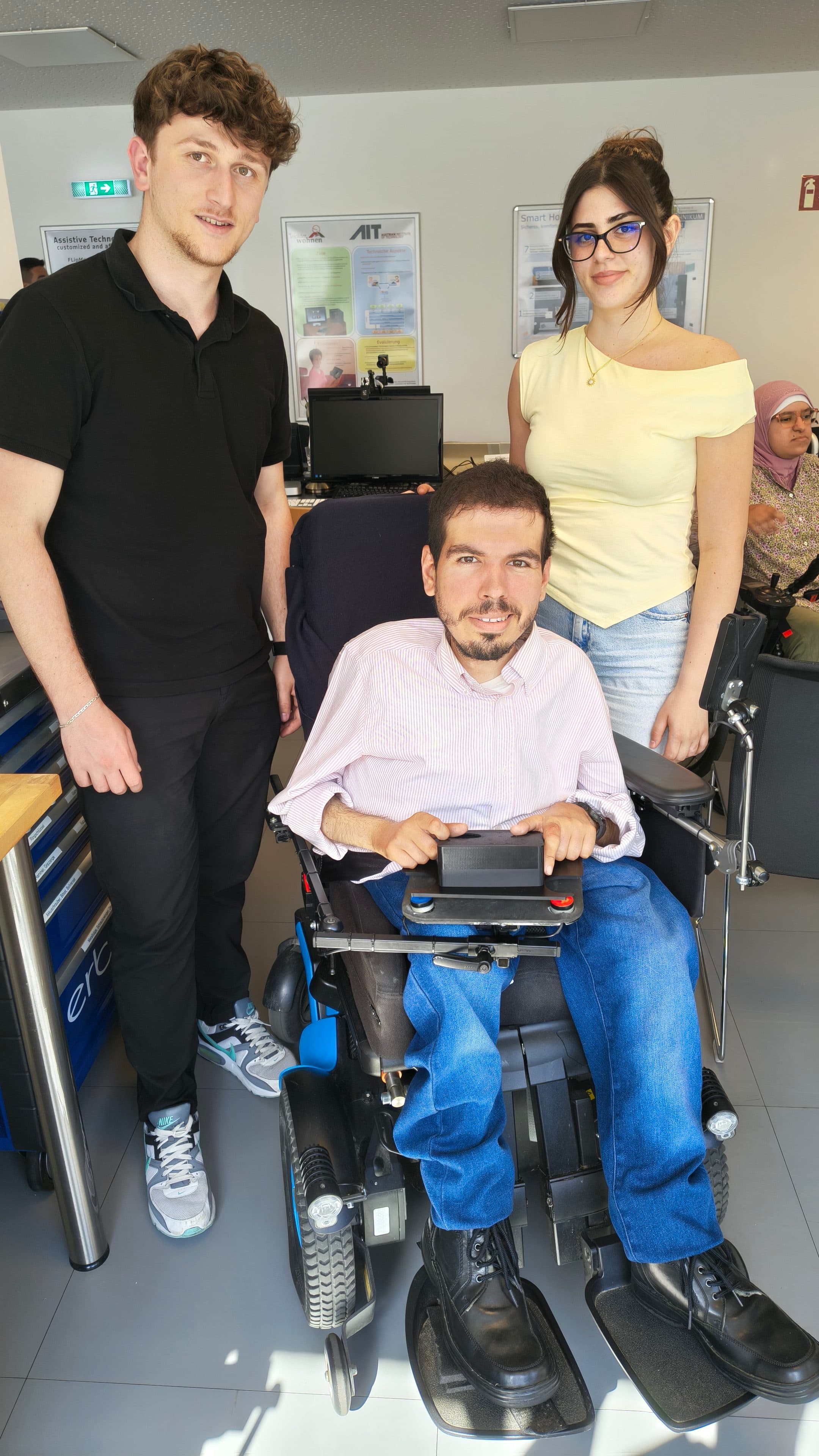 Group picture of the team CapacitiveKeyboard. In the middle Oliver tests the keyboard on his wheelchair table.